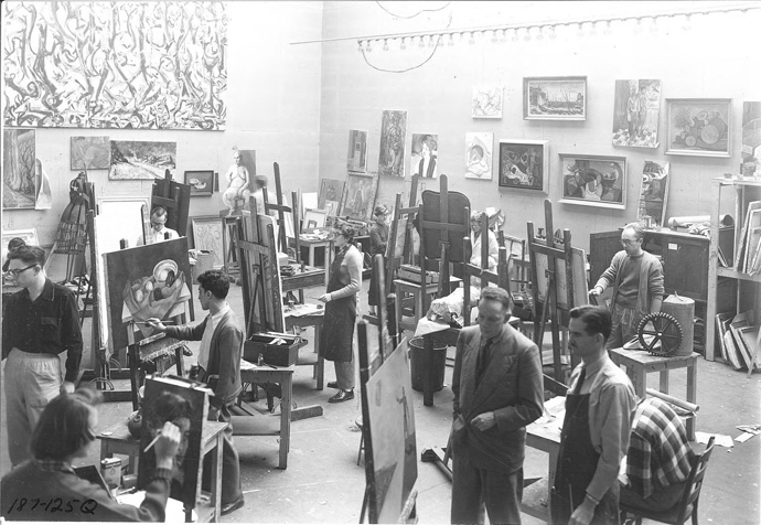 1952年アイオワ大学で、演習室に展示されたポロックの《壁画》の前で制作する学生たち Photo: Frederick W. Kent, Courtesy University of Iowa Libraries and Archives.